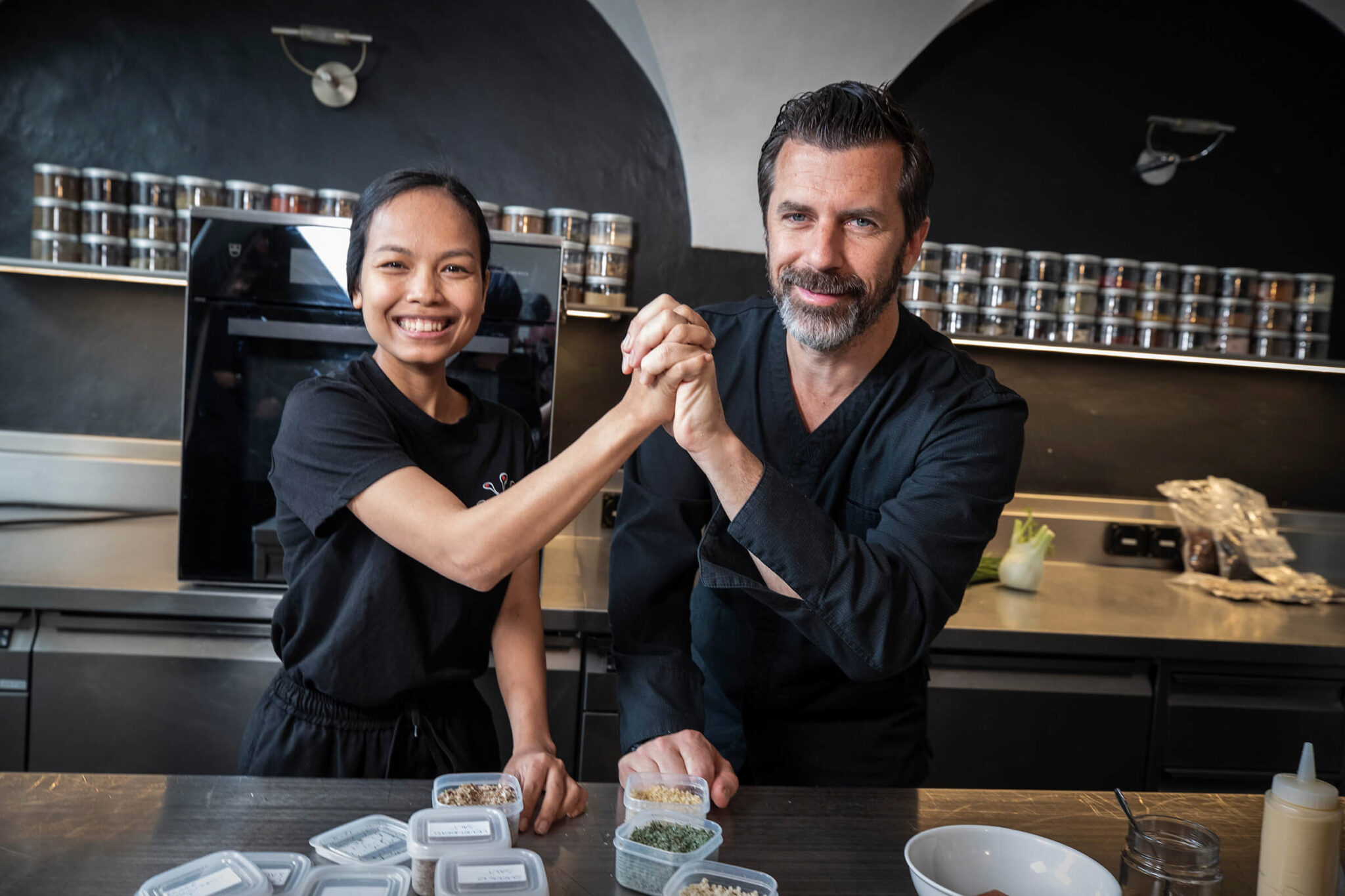 Mariya Un Noun and Andreas Caminada stand together in the kitchen.