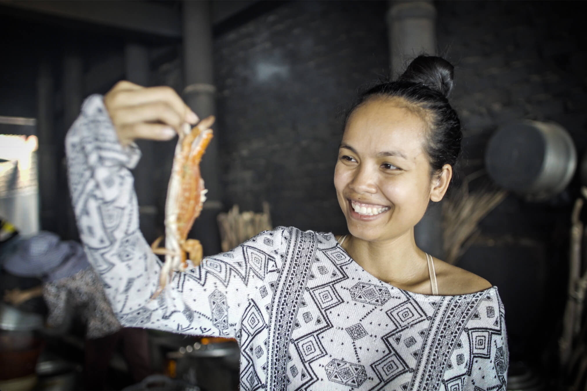 Mariya Un Noun holding freshly caught seafood.