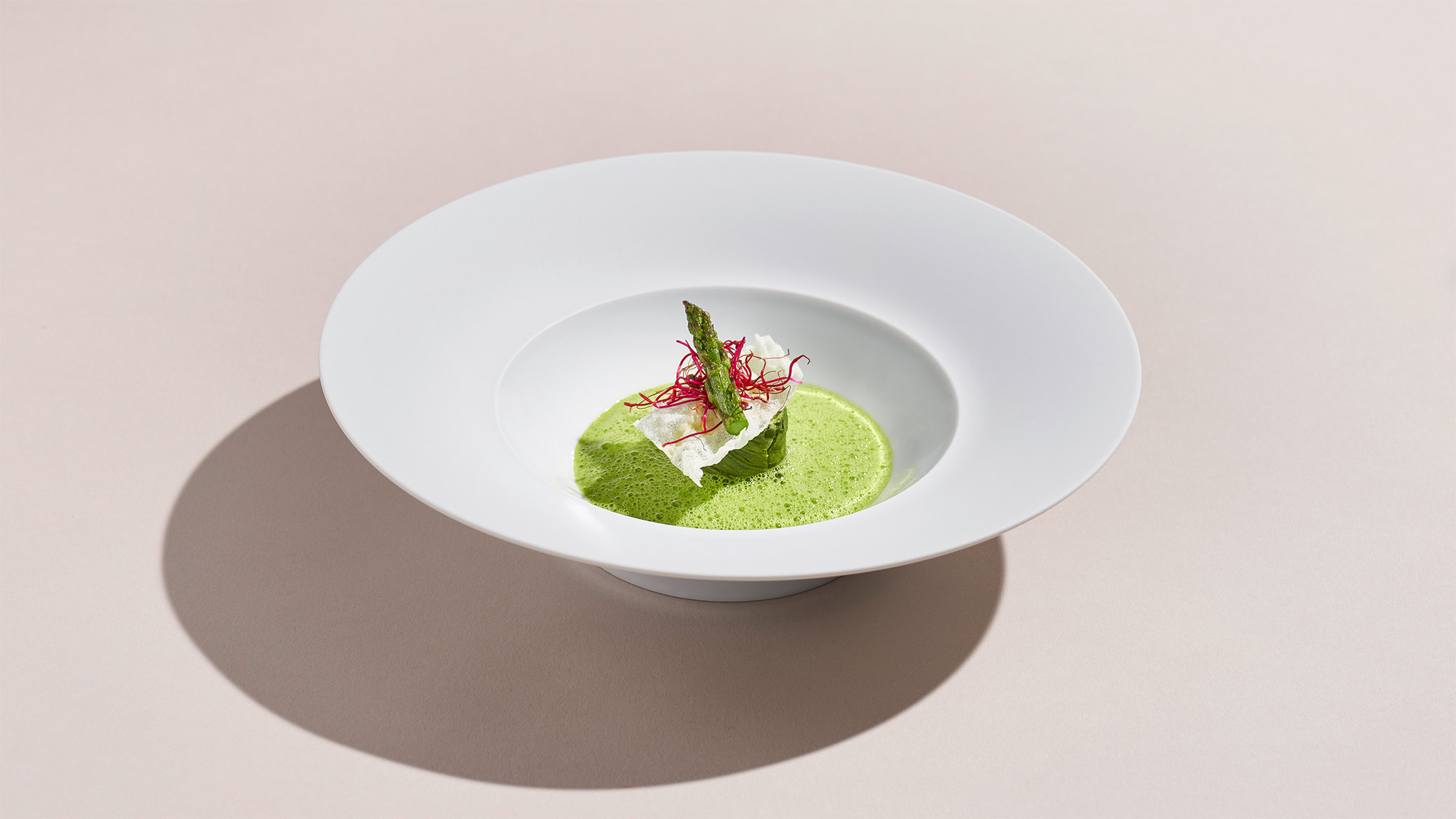 Plated chicken dish with green sauce.