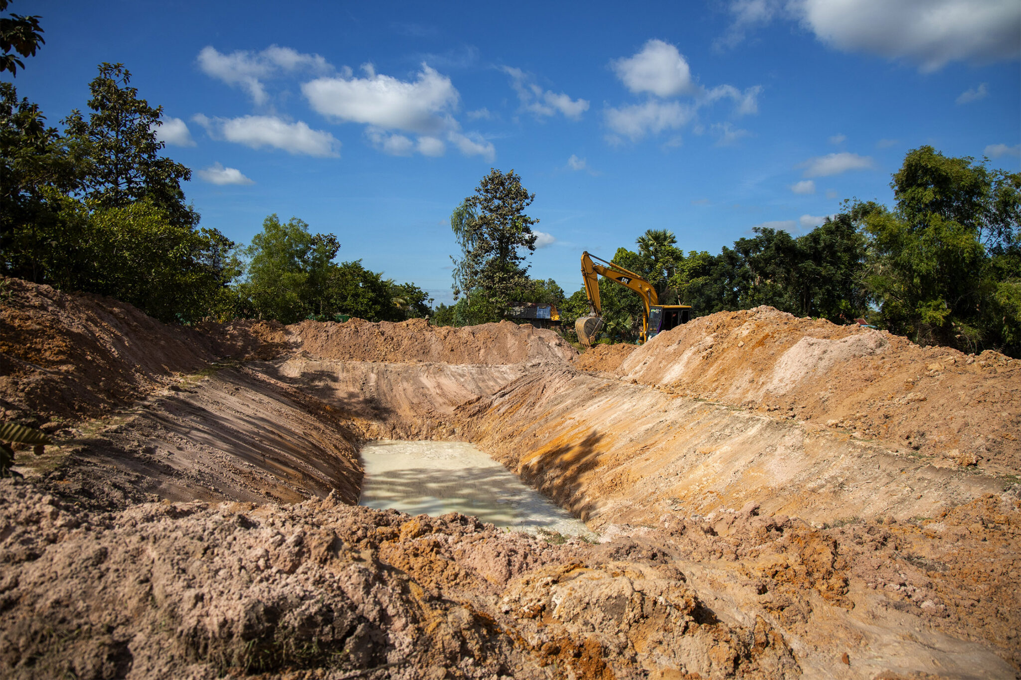 A newly excavated pond in a rural landscape.
