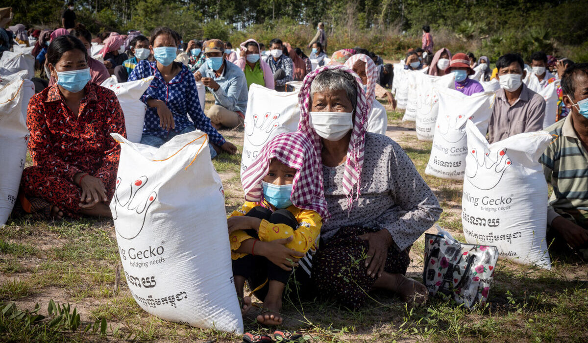 People with sacks of rice and food packages.