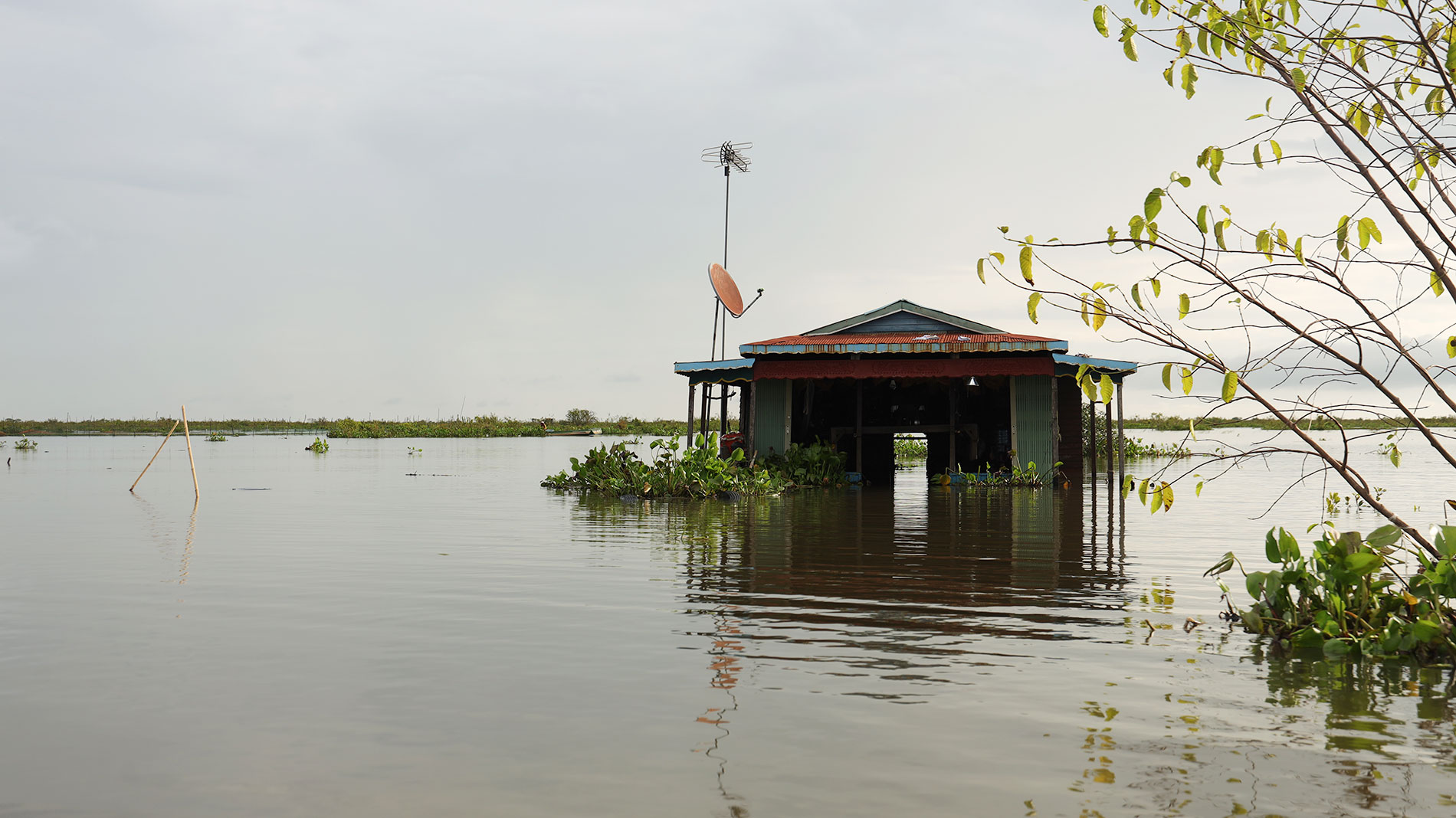 A house almost completely submerged by floodwater.