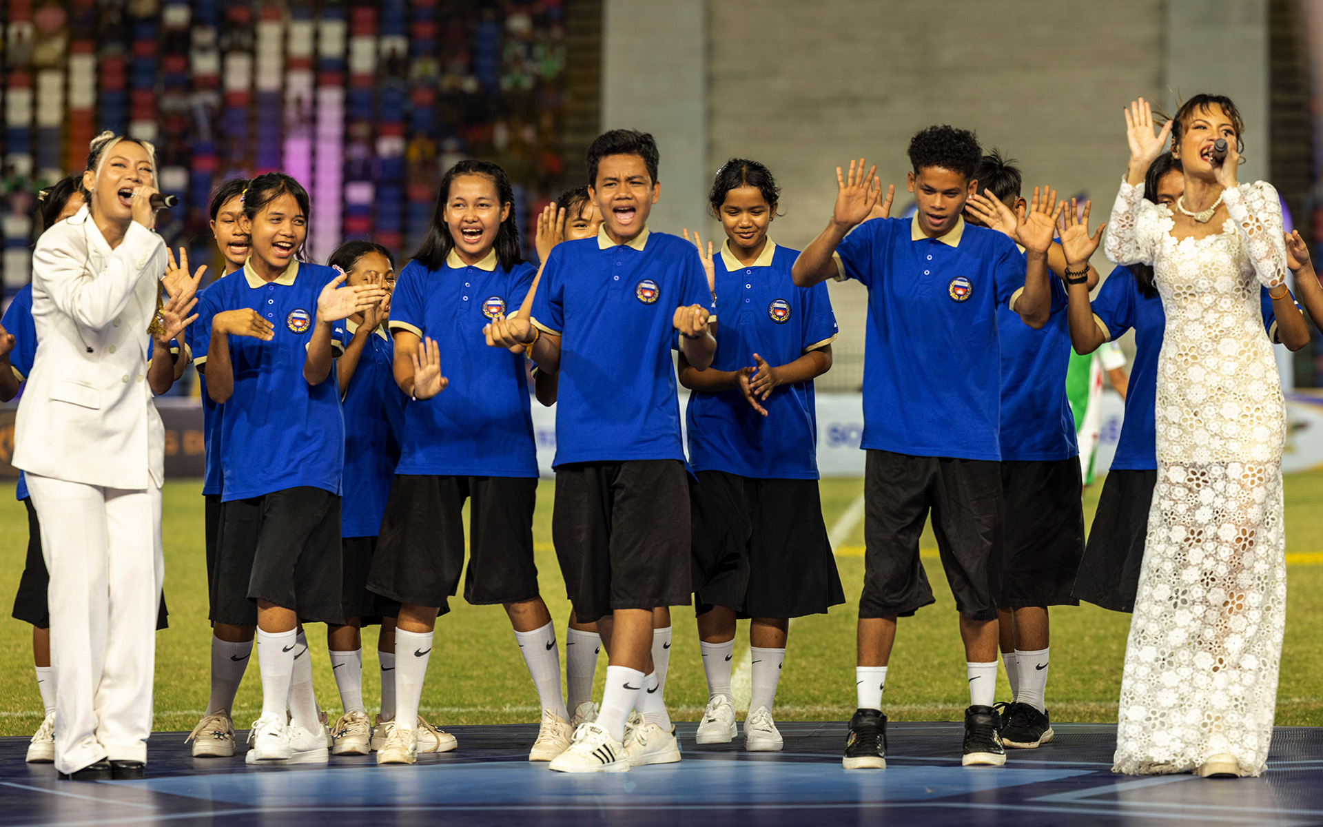 Schoolchildren performing together at the national stadium.