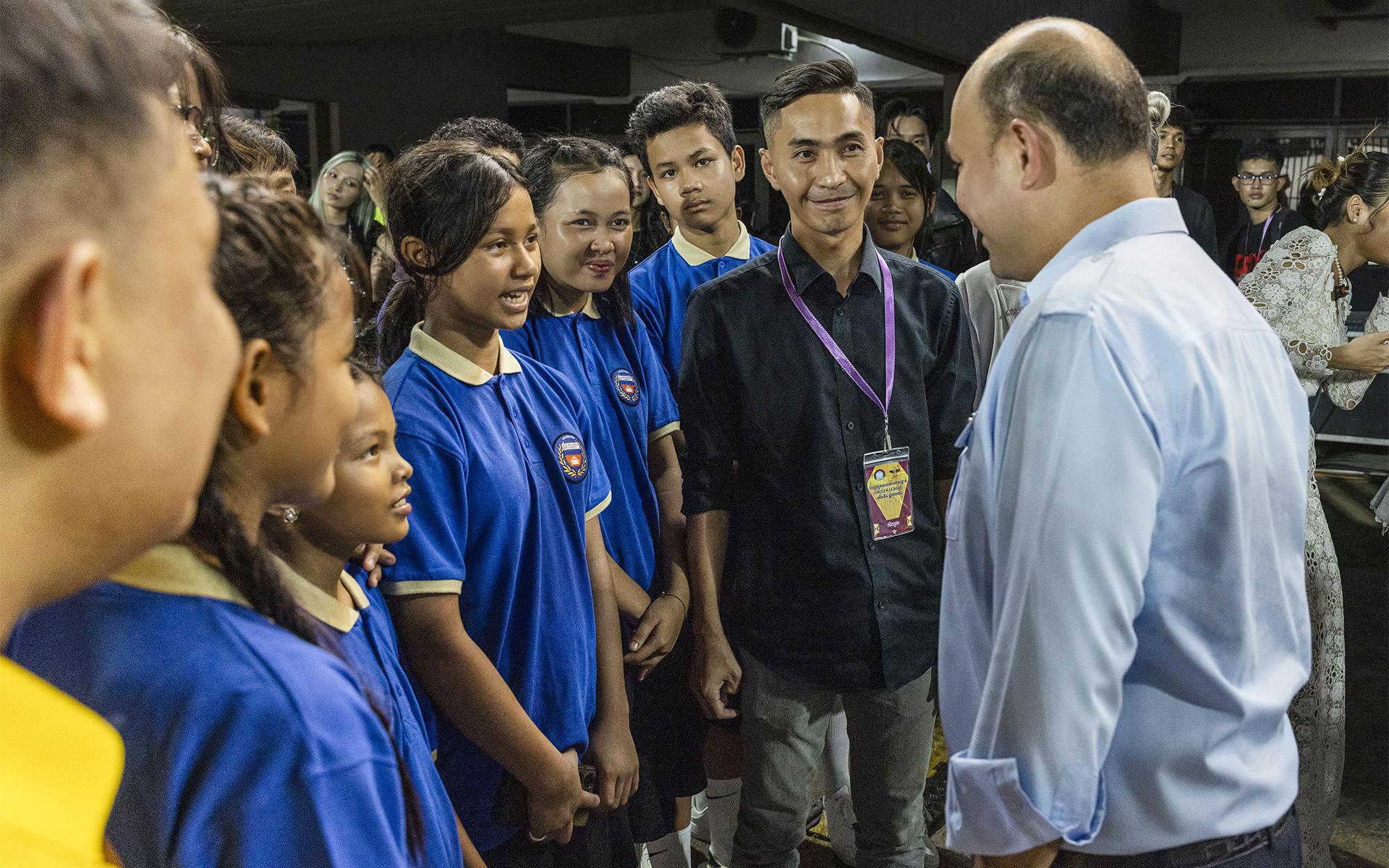 Schoolchildren talking with a visitor at the national stadium.