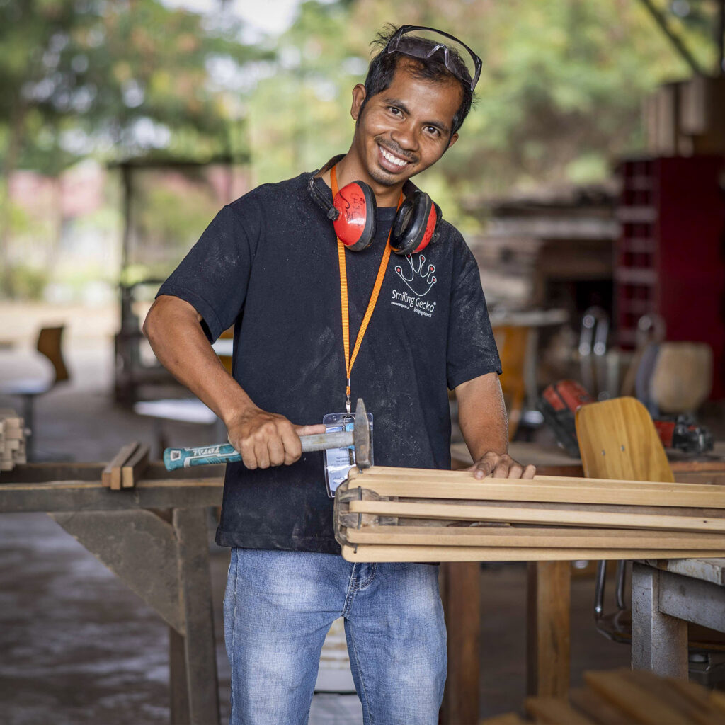 Pheara working with wood in the carpentry workshop.